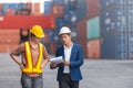Asian foreman holding clipboard and engineering women work at  containers in cargo ship. Royalty Free Stock Photo