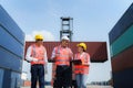 Asian foreman walking and explaining the various operations in the container depot terminal to worker