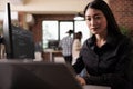 Asian freelance coder analyzing compiling html code