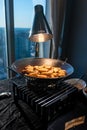 Asian fried eggrolls dish being cooked on the stove under a light near the window Royalty Free Stock Photo