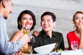 Asian friends dining in fancy restaurant Royalty Free Stock Photo