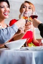 Asian friends dining in fancy restaurant Royalty Free Stock Photo