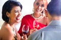 Asian friends drinking wine in bar Royalty Free Stock Photo