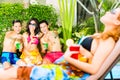 Asian friends partying at pool party in hotel Royalty Free Stock Photo