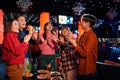 Asian friends singing into microphone at karaoke party at club Royalty Free Stock Photo