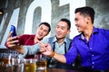 Asian friends taking pictures or selfies in fancy night club Royalty Free Stock Photo