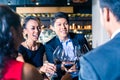 Asian friends toasting with red wine in bar