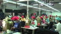 Asian Garment Industry Factory: WS tilt down to workers on floor