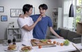 Asian gay couple cooking on kitchen.LGBT men couple are having fun together while preparing healthy food.Healthy lifestyle concept Royalty Free Stock Photo