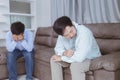 Asian gay couples are quarreling, angry or sad on sofa in home, LGBTQ concept.