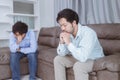 Asian gay couples are quarreling, angry or sad on sofa in home, LGBTQ concept.