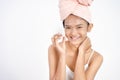 asian girl applying facial moisturizer while holding jar Royalty Free Stock Photo