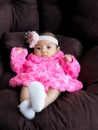 An Asian girl baby wearing a pink shirt lying on the sofa with comfort Royalty Free Stock Photo