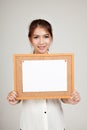 Asian girl with blank paper pin on cork board