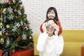 Asian girl blindfolded her mother to make a surprise. Girl is holding a gift box and covering mom eyes making a surprise. Girl Royalty Free Stock Photo