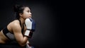 Asian girl boxer posing with blue boxing gloves