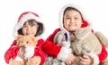 Asian girl and boy in santa costume hugging bear doll on christmas Royalty Free Stock Photo