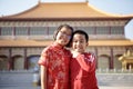 Asian girl and boy wearing red chinese suit happiness against china temple background