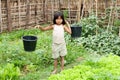 Asian girl carry water bucket