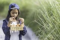 An Asian girl is carrying a basket containing eggs Royalty Free Stock Photo