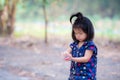 An Asian girl caught a red toy car on her palm. She plowed it back and forth on her body. Royalty Free Stock Photo