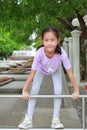 Asian girl child enjoy to climbing aluminum fence in public park Royalty Free Stock Photo