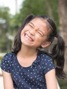 Asian girl child kid showing front teeth with big smile Royalty Free Stock Photo