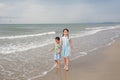 Asian girl child and little boy walking together on tropical sand beach. Happy family sister and brother enjoy in summer holiday Royalty Free Stock Photo