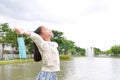 Asian girl child relax and breathing deep fresh air relieving taking off mask due covid-19 on the garden Royalty Free Stock Photo