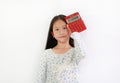 Asian girl child showing Calculator on white background. Kid holding a red calculator Royalty Free Stock Photo
