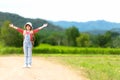 Asian girl children raise arms and standing see the outdoors, adventure and tourism for destination and leisure trips with mountai