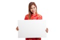 Asian girl in chinese cheongsam dress with red blank sign Royalty Free Stock Photo