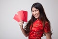 Asian girl in chinese cheongsam dress with red envelope Royalty Free Stock Photo