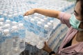 Asian girl choosing pure fresh water or buying and hoarding during the COVID-19 Coronavirus pandemic,selecting clean water,