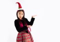 Asian girl in christmas theme costume wear santa hat headband hand presenting and point copy Royalty Free Stock Photo