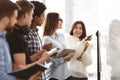 Asian girl and classmates discussing answers to tasks Royalty Free Stock Photo