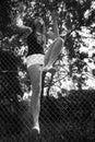 Asian girl climbing fence