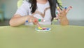 Asian girl with colorful fingers painted in the children room