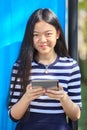 asian girl and computer tablet in hand standing with toothy smiling face use for people and internet connecting ,communication in