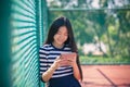 asian girl and computer tablet in hand standing with toothy smiling face use for people and internet connecting ,communication in