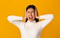 Asian girl covering her ears and shouting Royalty Free Stock Photo