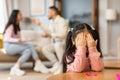 Asian Girl Crying Covering Eyes While Parents Having Quarrel Indoor Royalty Free Stock Photo