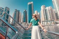 Girl on a deck of cruise ship enjoying great view of skyscrapers of Marina port in Dubai Royalty Free Stock Photo