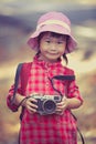 Asian girl with digital camera in beautiful outdoor. Vintage pic Royalty Free Stock Photo