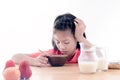 Asian girl don't want to eat his breakfast Royalty Free Stock Photo