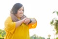 Asian girl with down syndrome watching exercise watch By walking to burn fat and jogging to exercise in the park