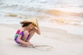 Asian girl draw heart shapes in the sand ,summer beach love concept Royalty Free Stock Photo