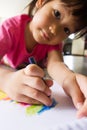 Asian girl drawing a picture.