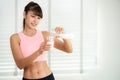 Asian girl drink a milk after work out in fitness center Royalty Free Stock Photo