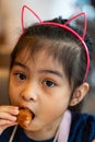 Asian girl Eating Chicken. child eating a chicken nuggets